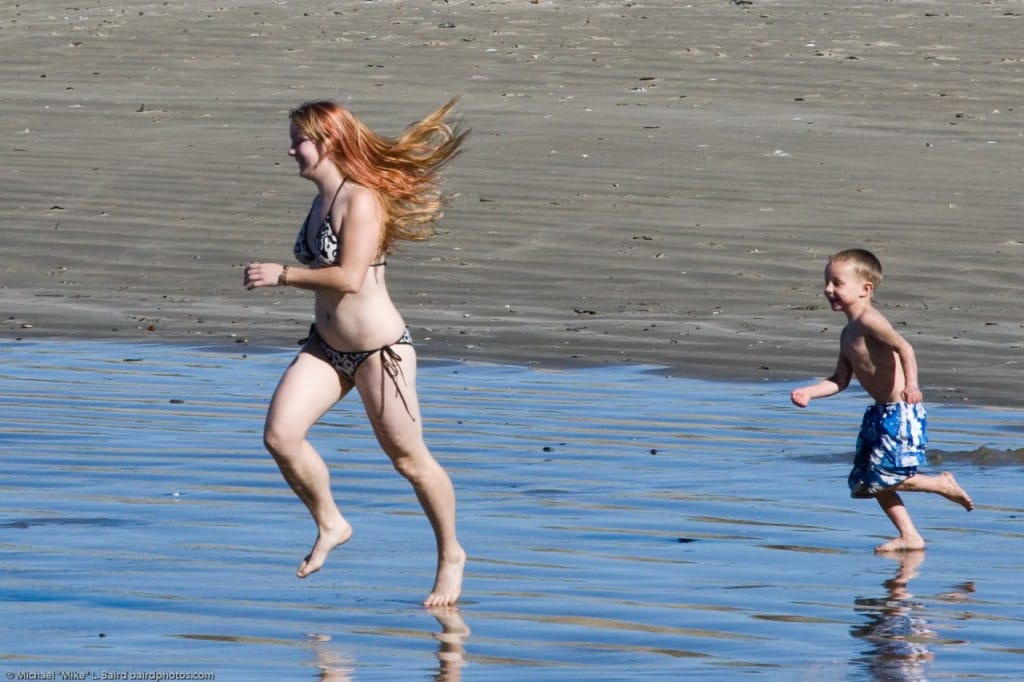 5 of 5 Mother with son playing in the water at Morro Bay beach